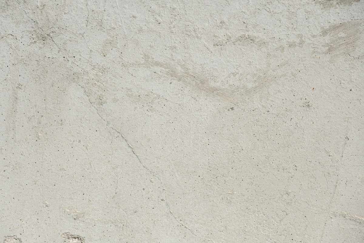 Close view of a pale limestone surface showing fine mineral grain and natural veining